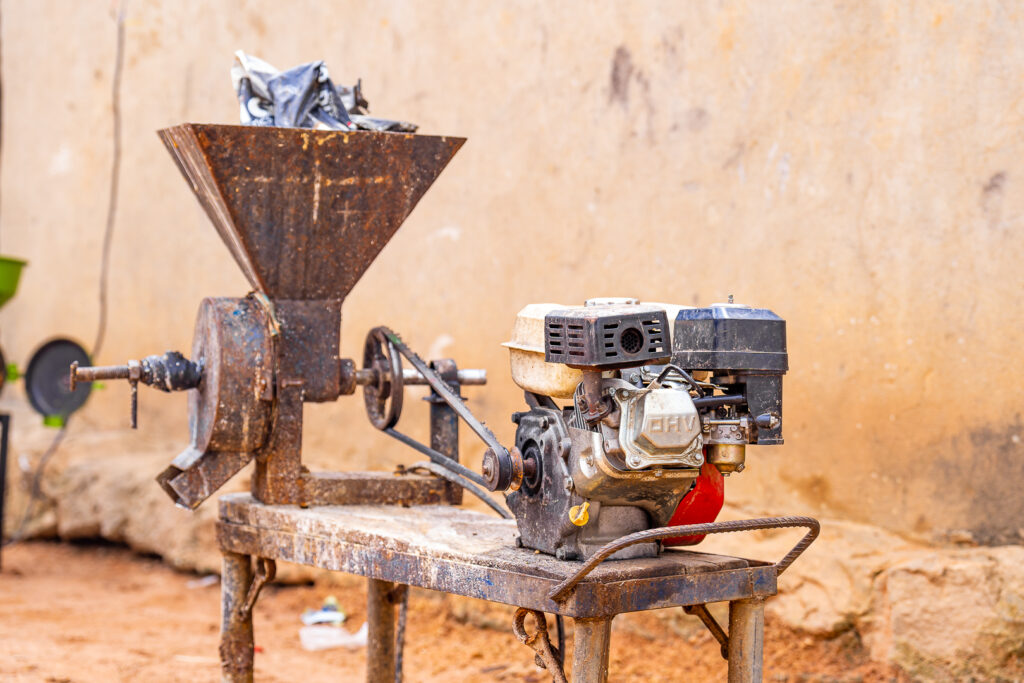 Gasoline grinder sitting idle in rural Nigerian community.